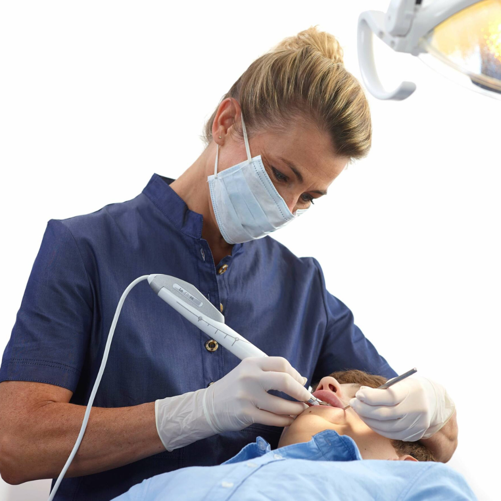 A dental professional using the QuickSleeper handpiece.
